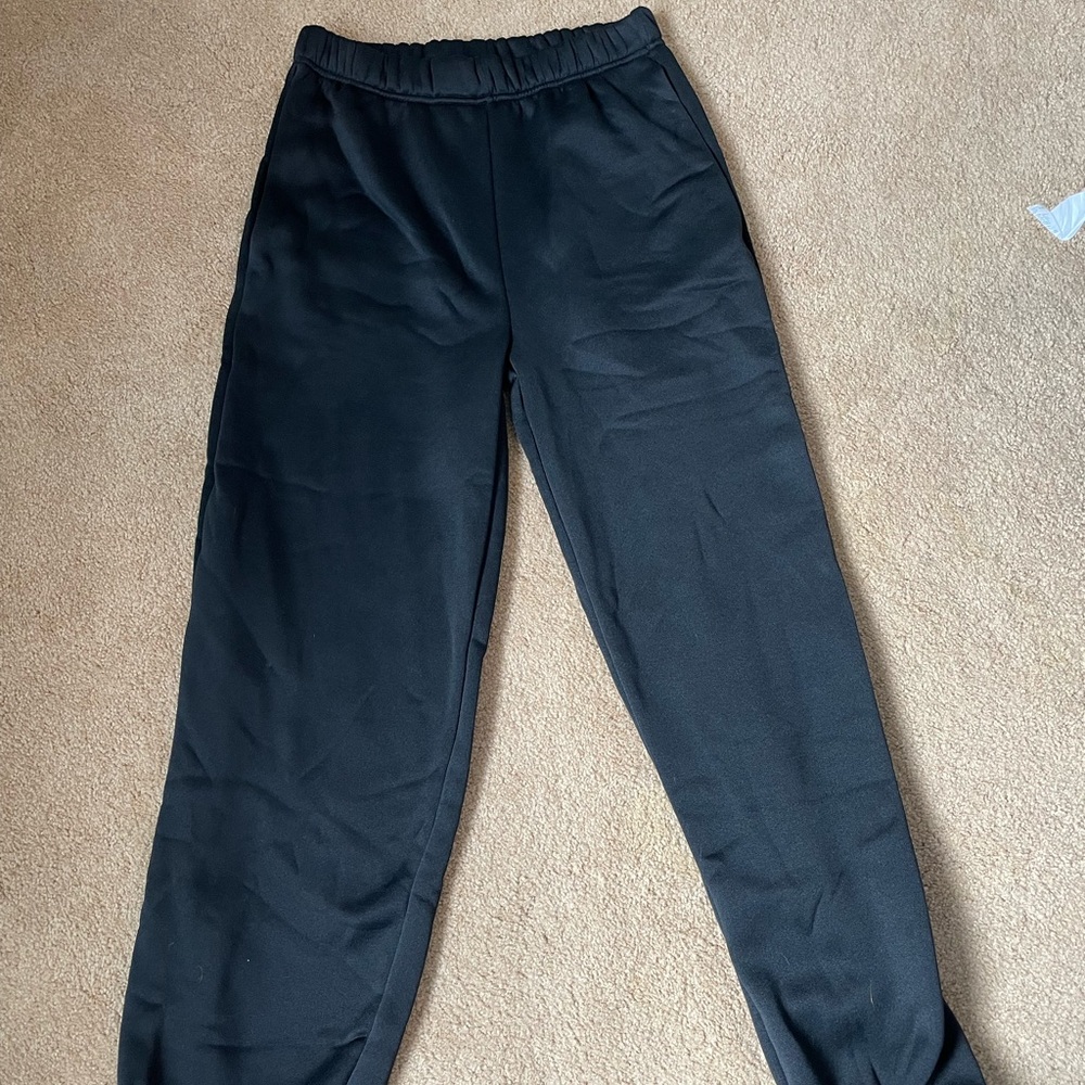 Medium, basic black sweat pants.